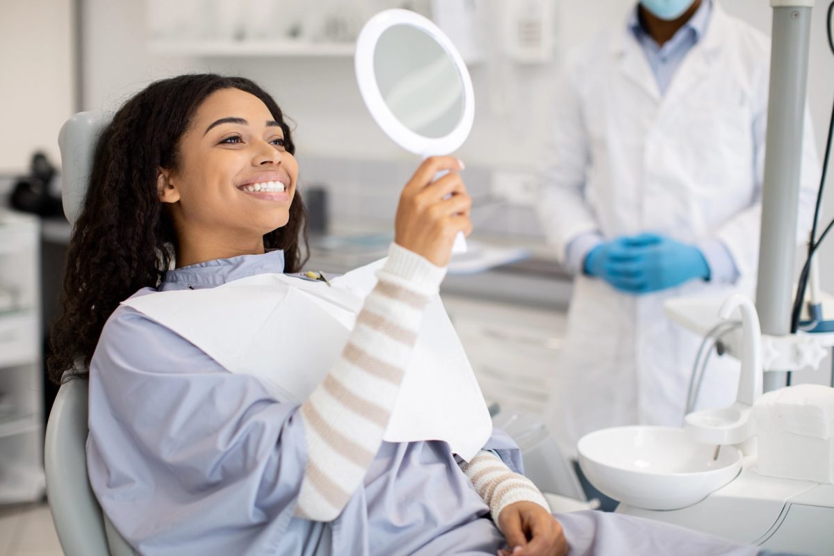 A patient smiling in a dental treatment room